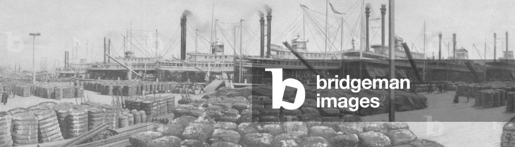 Steamships Lined Up At A Dock With Cotton Cargo Unloaded On The Dock, c.1920s (b/w photo)