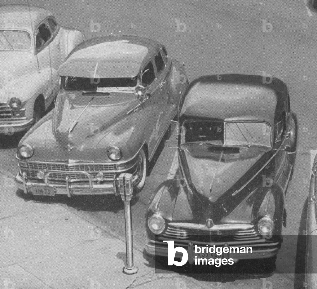 Diagonally Parked Cars In Front Of ALFCO Twin Parking Meters
