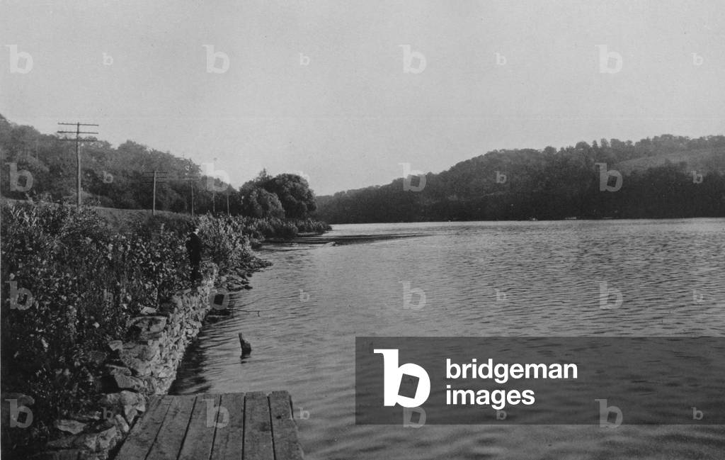 A Man Standing On The Bank Of The Schuylkill River