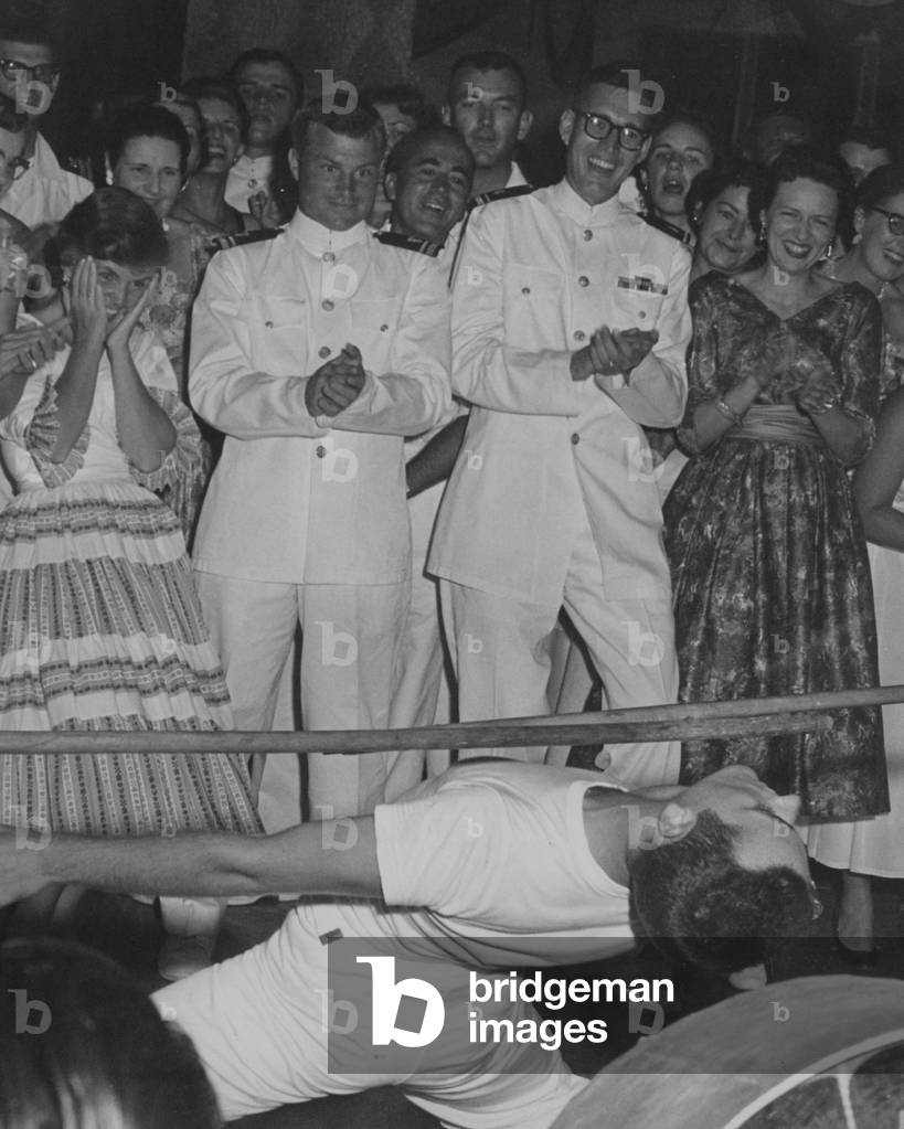 A Crowd Watches A Sailor Do The Limbo