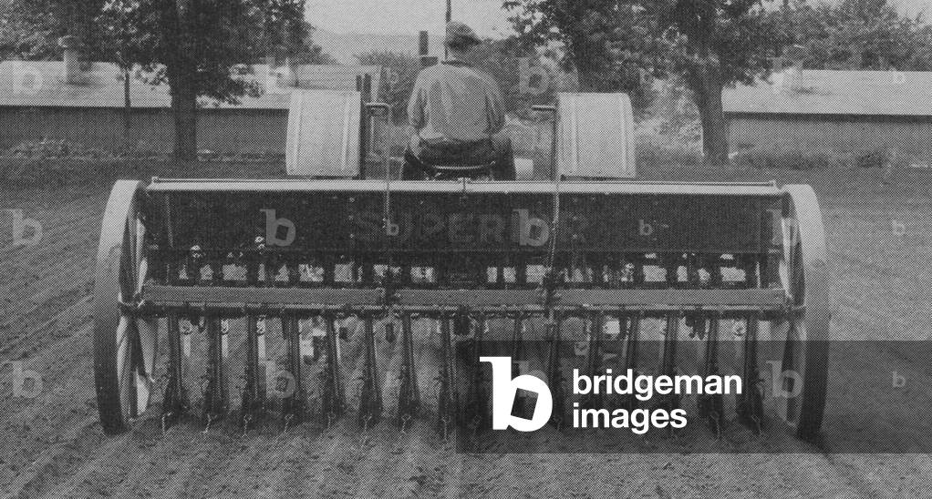 Farmer Planting And Seeding Using a Row Crop Tractor Equipped With Tiptoe Wheels