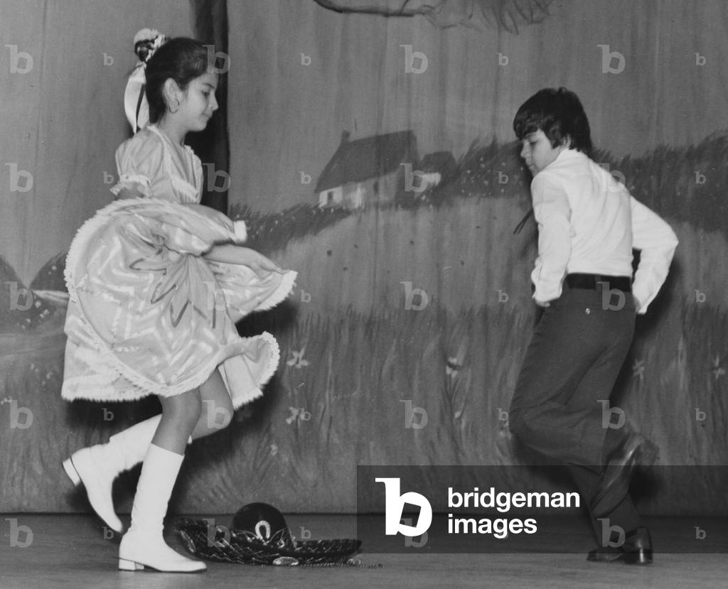 Two Young Children Performing A Mexican Hat Dance