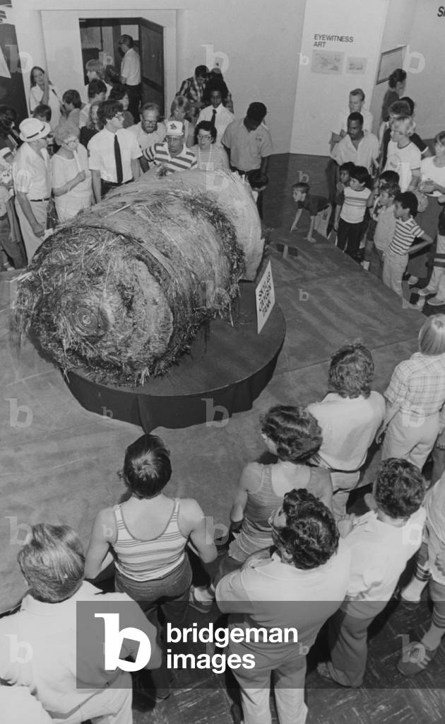A Group Of People Looking At One Of The Oxygen Tanks From Skylab On Display