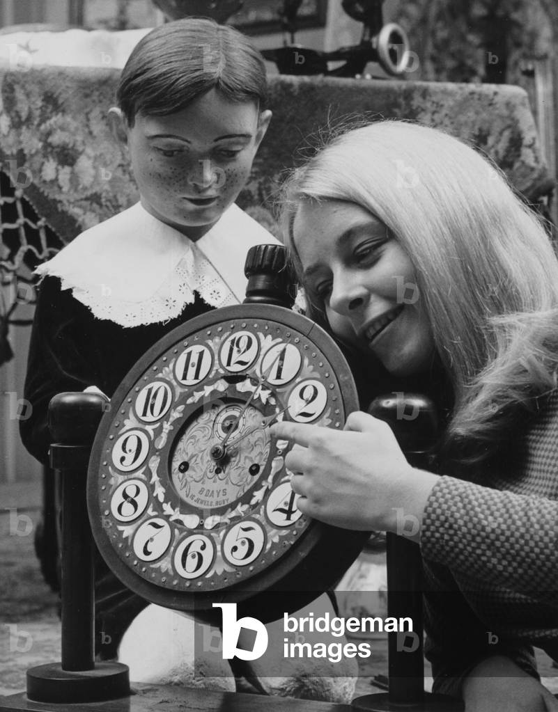 A Woman Poses With An Unusual Clock