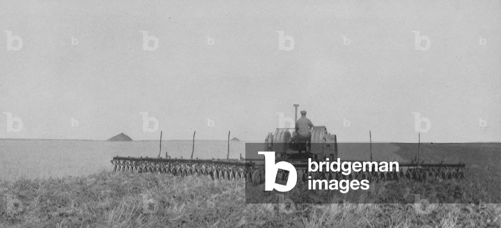 A Thirty-Two Foot Oliver Wide Disc Harrow Attached To A 18-36 Hart Parr Tractor