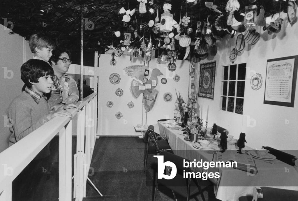 A Group Of People Looking At A Festive Jewish Display