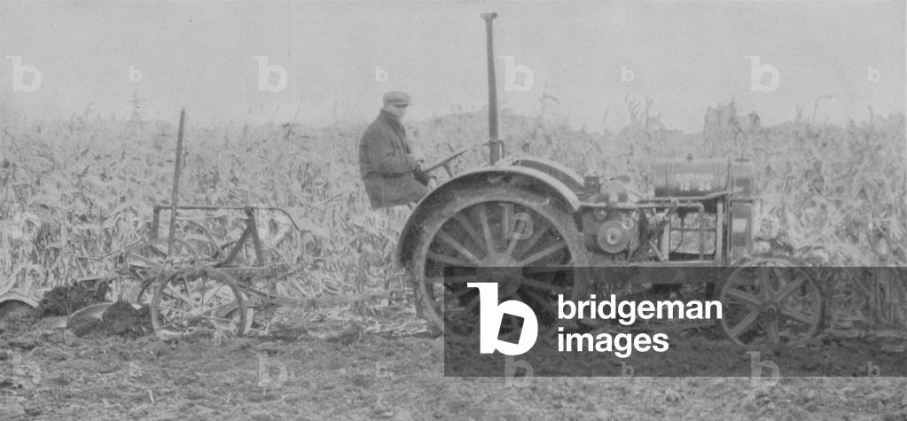 A Oliver 218 Big Base Plow With A 12-24 Hart Parr Tractor