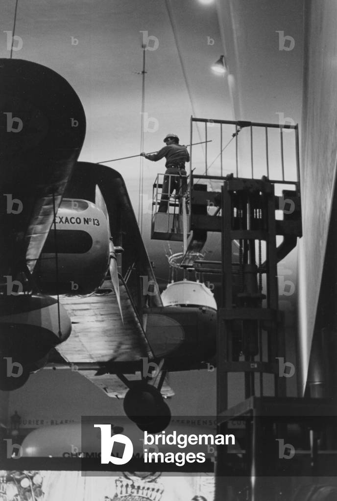 A Museum Employee Cleaning One Of The Planes On Display Inside The Museum Of Science And Industry