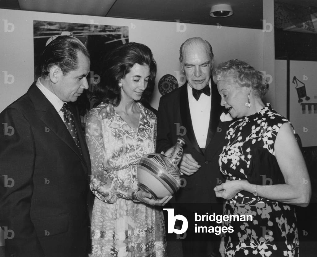 A Group Of Distinguished Guests Viewing Traditional Mexican Pottery