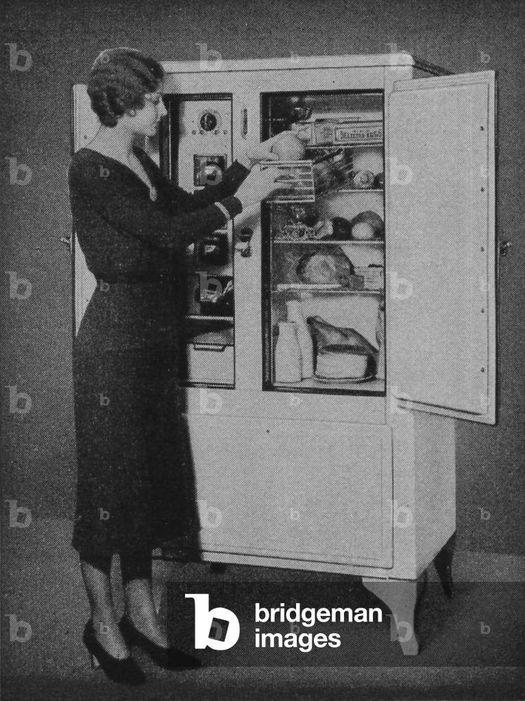 A Woman Opens A Copeland Refrigerator Cabinet