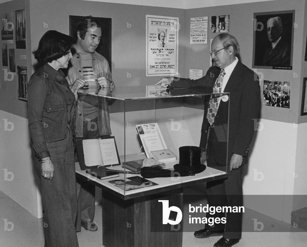 A Group Of People Viewing A Display About Tody Greenberg