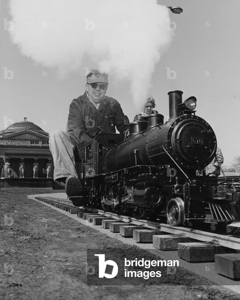 A Man Riding A Model Steam Locomotive Outside The Museum Of Science And Industry