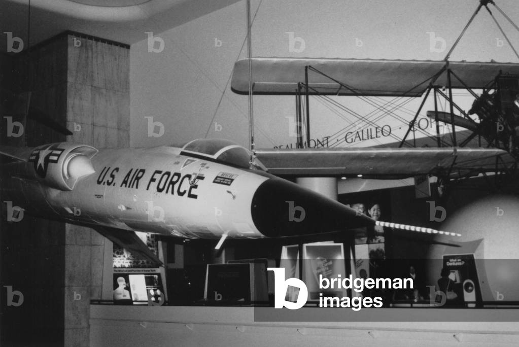 A United States Air Force Jet Hanging Next To A Bi-Wing Plane Inside The Museum Of Science And Industry