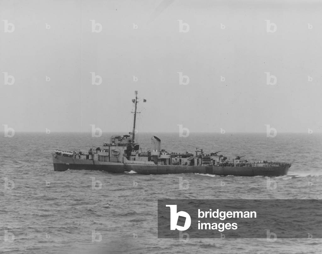 The USS Chatelain At Sea With The Crew Gathered On The Bow
