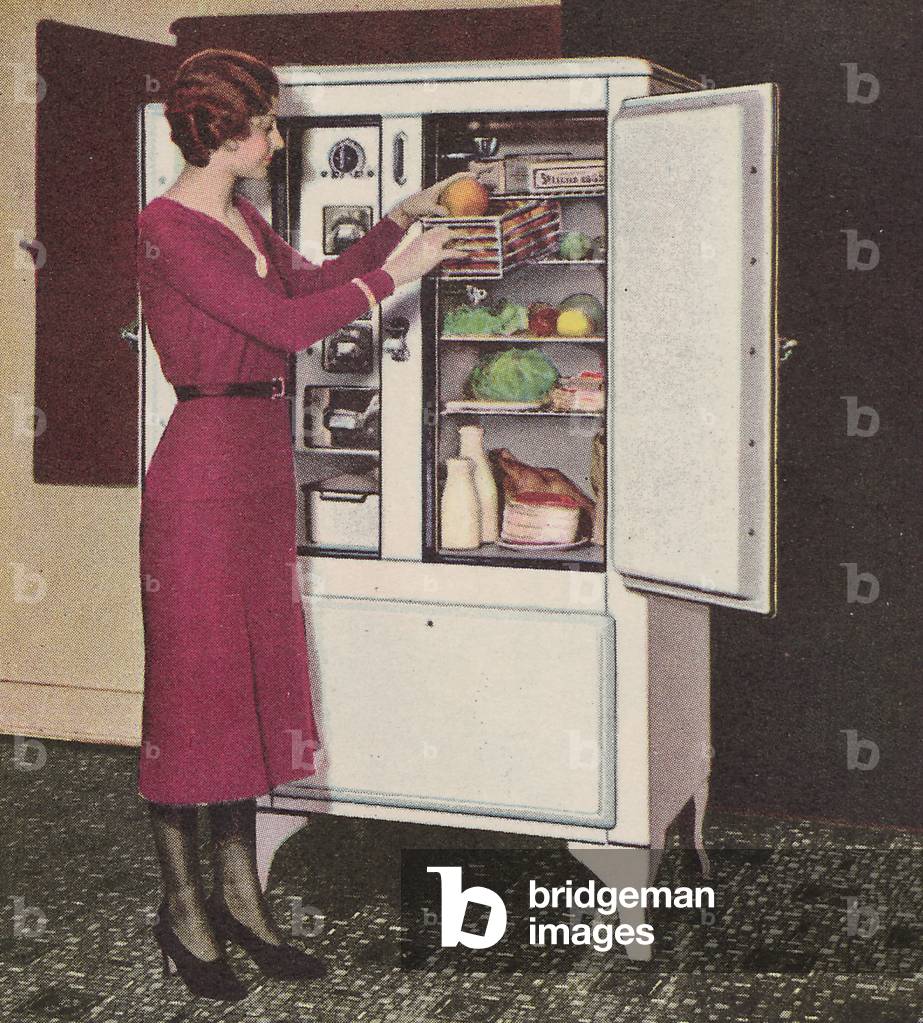 A Woman Showing The Ample Storage Space, Sliding Shelf And Slide Basket Of A Copeland Refrigerator Cabinet