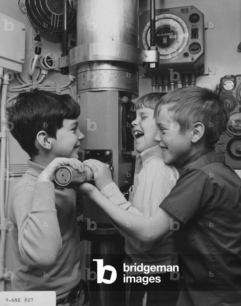 A Group Of Boys Take Turns Looking Through A Periscope Interactive