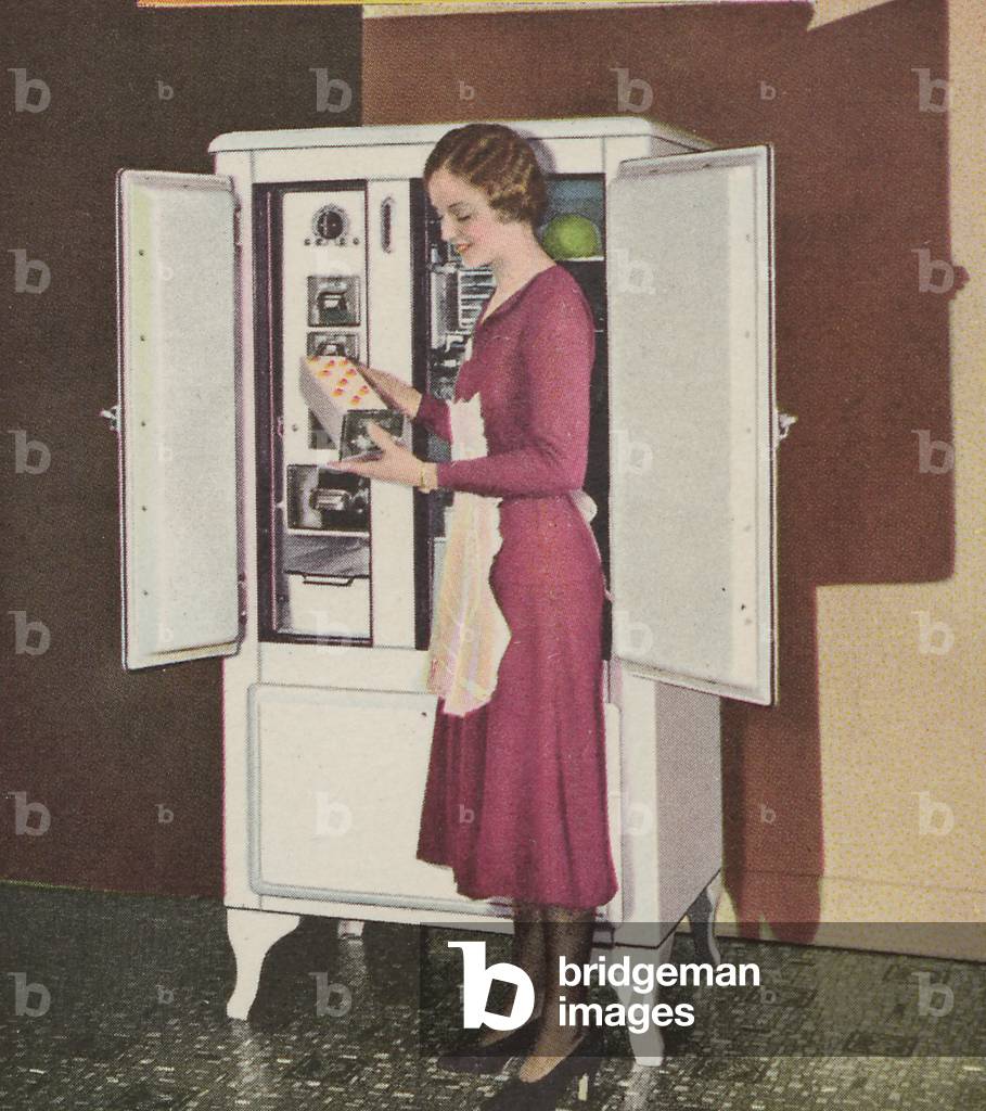 A Woman Takes A Frozen Desert From A Copeland Refrigerator/Freezer Cabinet