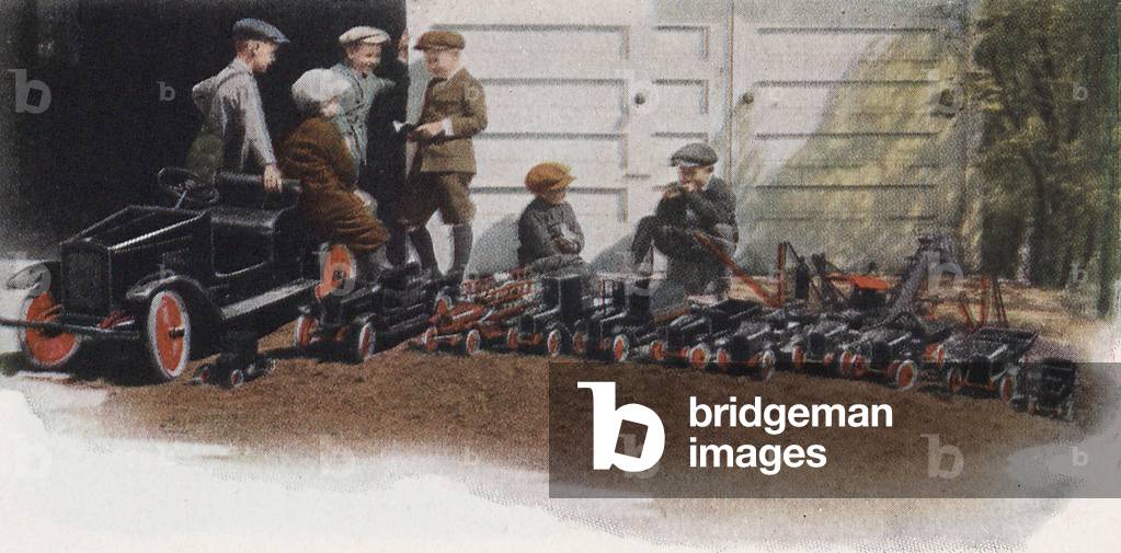 A Group Of Boys Outside A Garage With Various Buddy 'L' Toy Trucks