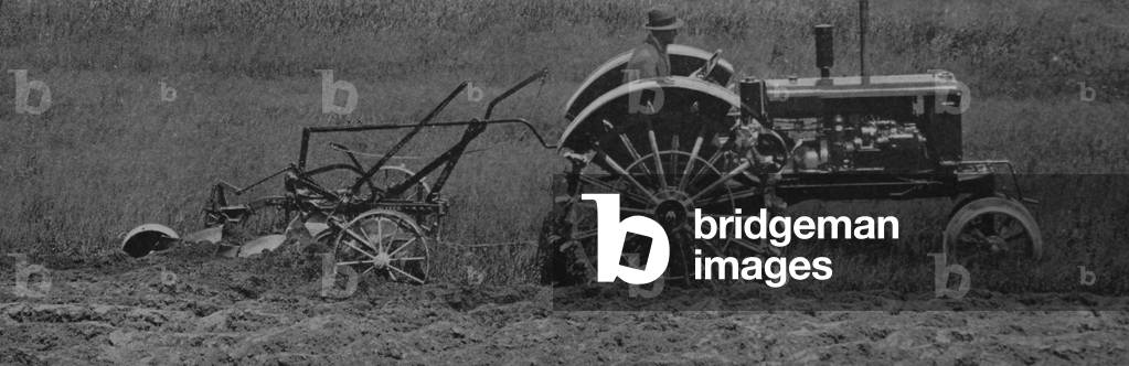 Tractor Equipped With Oliver Farm Tiptoe Wheels Pulling A Plow