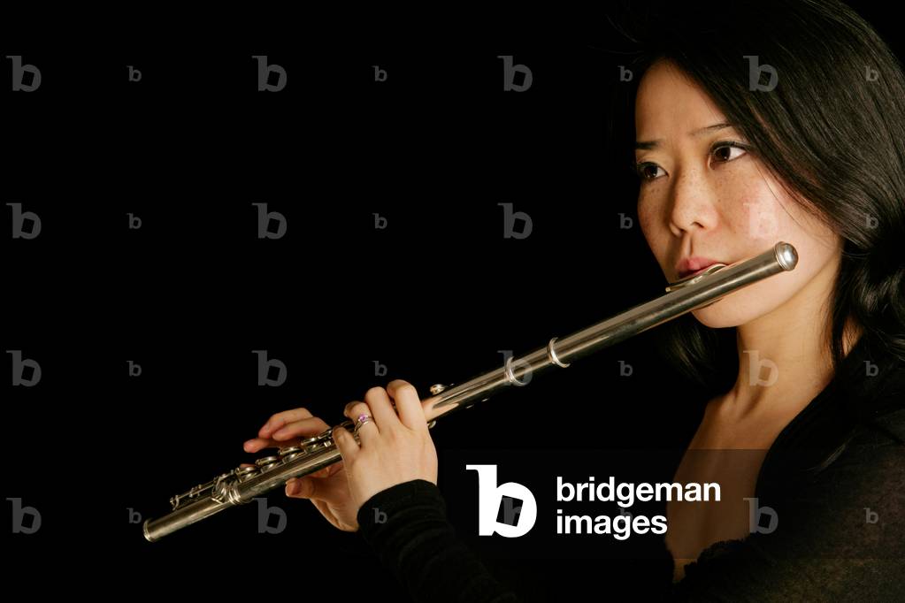 Young woman playing the flute