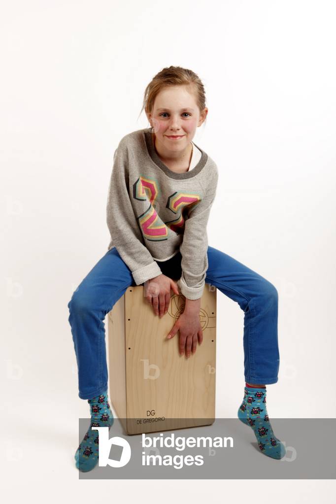 Cahon or Cajon being played by a young girl