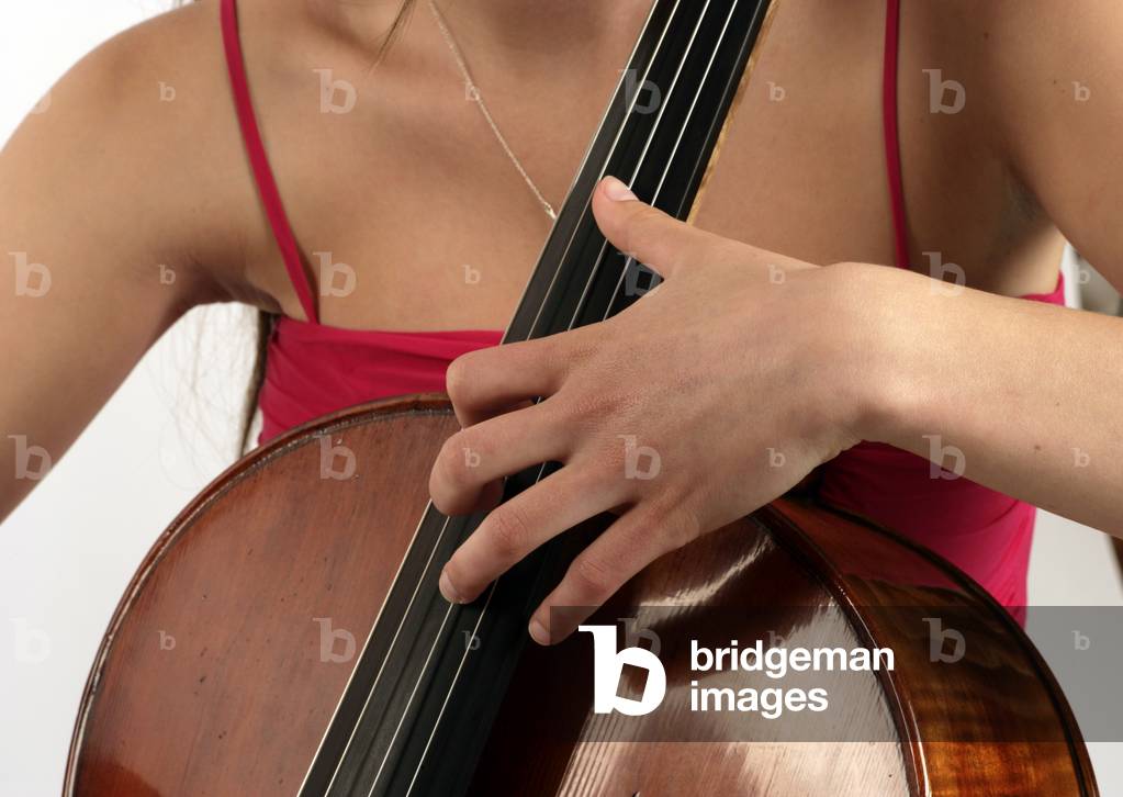 Cello - young woman playing double stopping on a cello. Left hand position. Cellist. Hand. Hands.