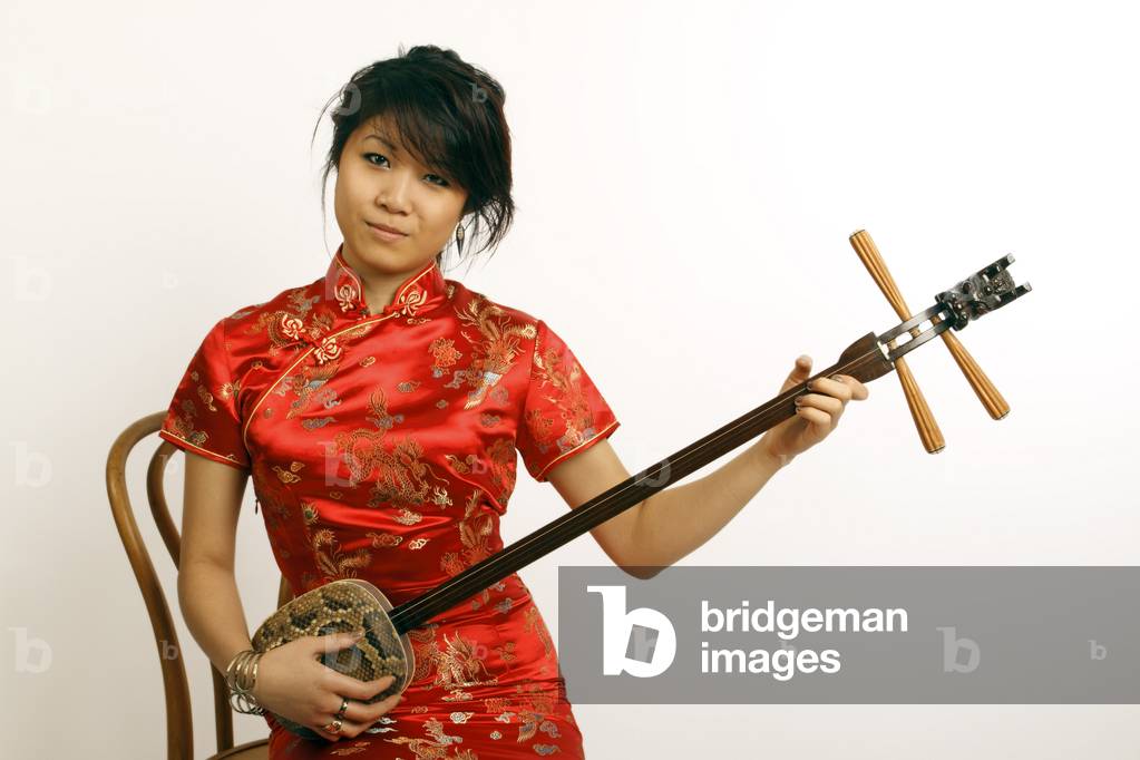 Chinese girl playing a Sanxian or San Hsien 3 stringed lute