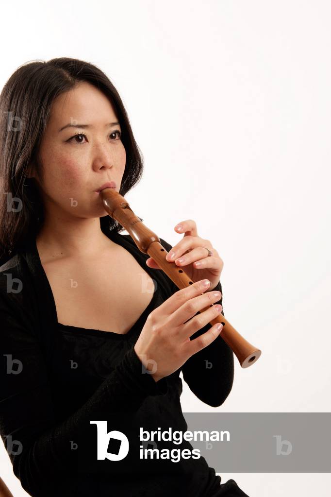Young woman playing a descant