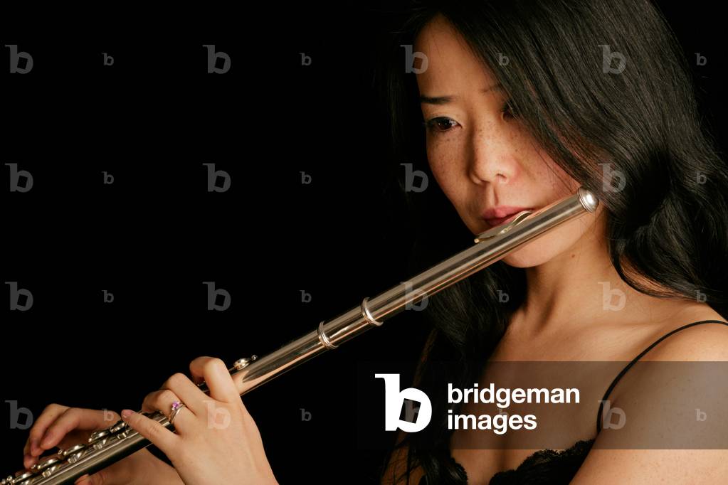 Young woman playing the flute