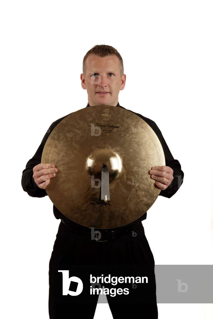 Percussion player holding a cymbal