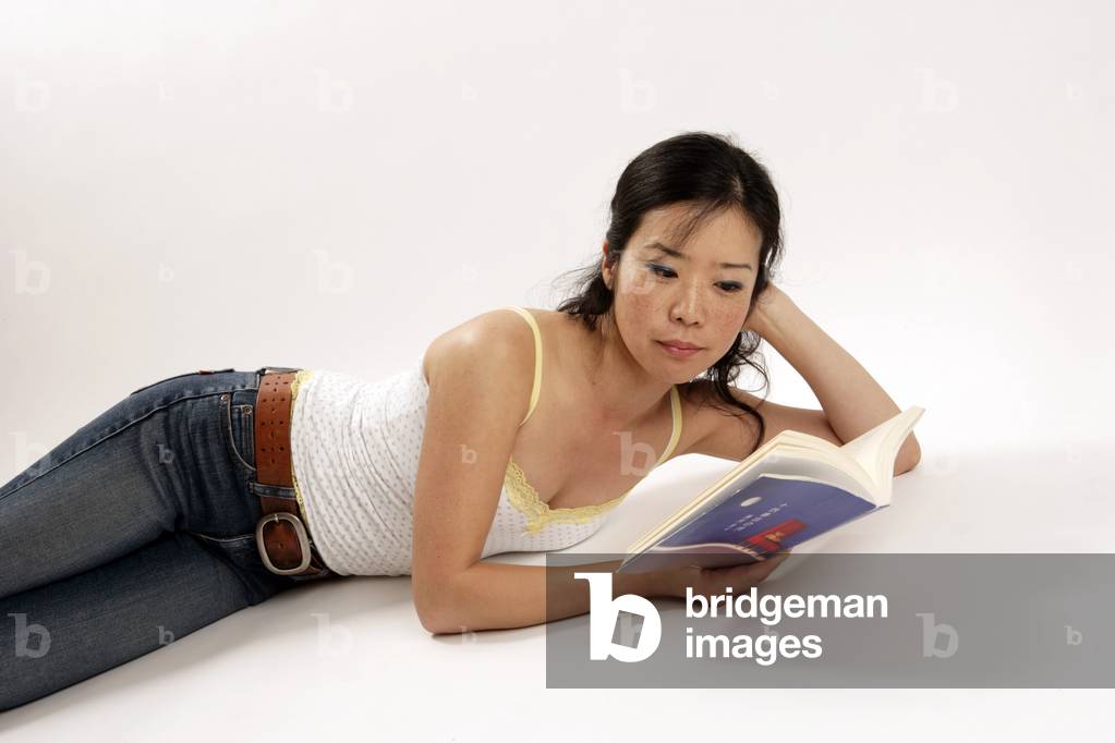 Literature - young oriental woman reading a Japanese book