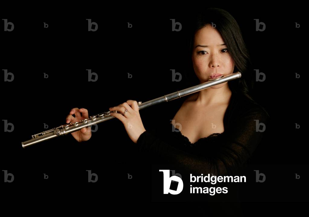 Young woman playing the flute