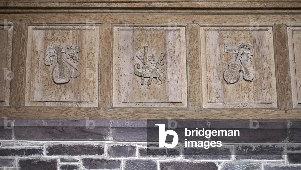 Baroque instruments, wooden relief in St David's cathedral, Pembrokeshire, West Wales.