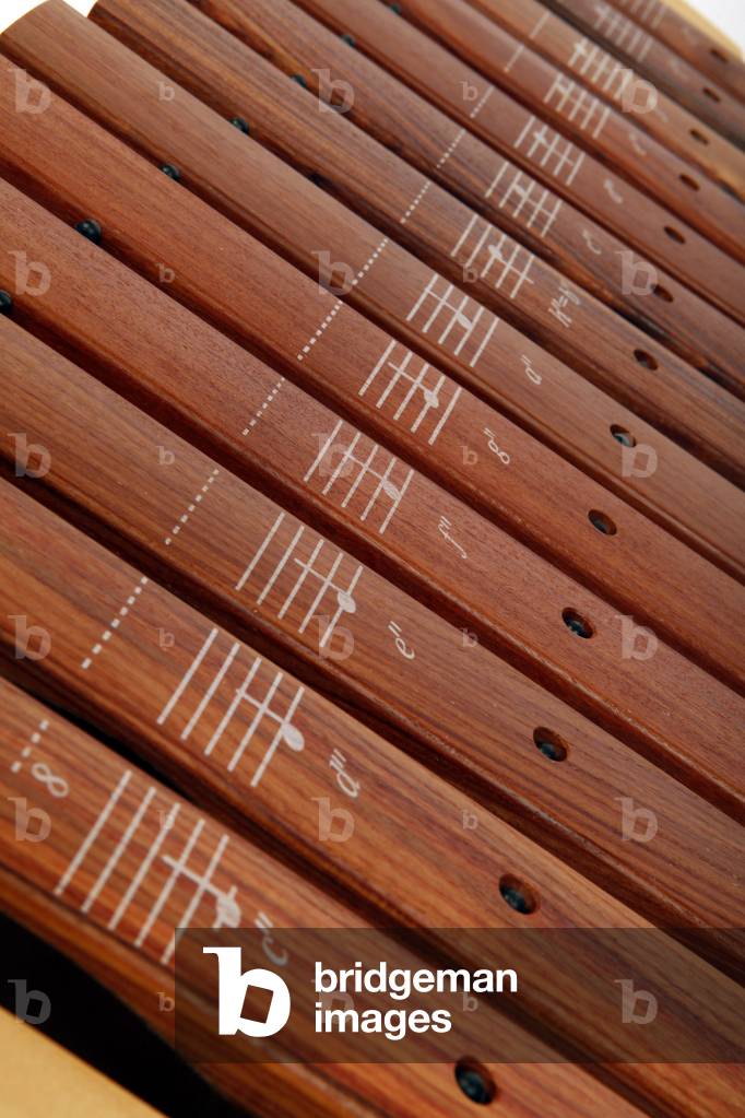 Close up detail of bars and the printed notes on them. On a primary or Junior school Soprano Xylophone with sticks - generic