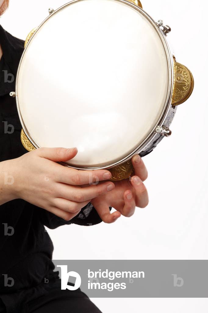 Riq, or Riqq, Egyptian Tambourine held vertically in one hand, and played by striking the skin with the other hand, as well as playing the heavy jingles with the fingers of both hands. Arabic. Generic