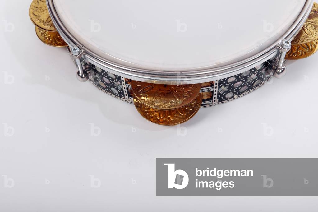 Riq, or Riqq, Egyptian Tambourine held vertically in one hand, and played by striking the skin with the other hand, as well as playing the heavy jingles with the fingers of both hands. Arabic. Generic