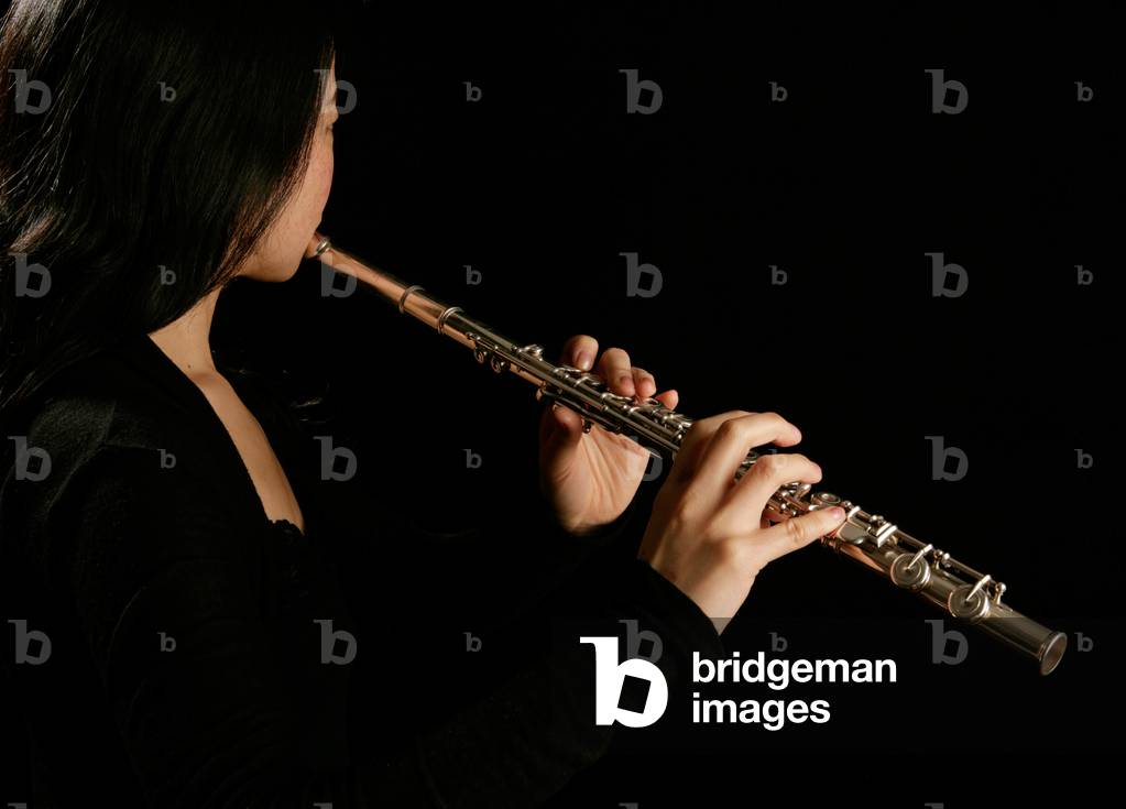 Young woman playing the flute