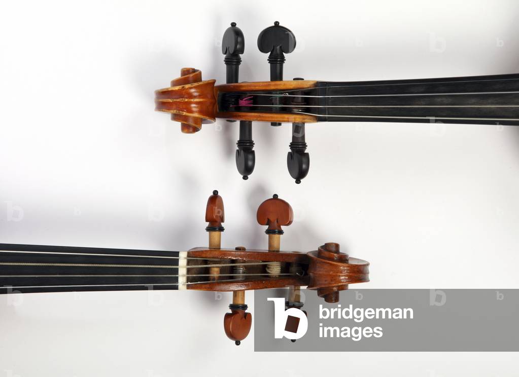 Two violin scrolls, one baroque, one classical violin