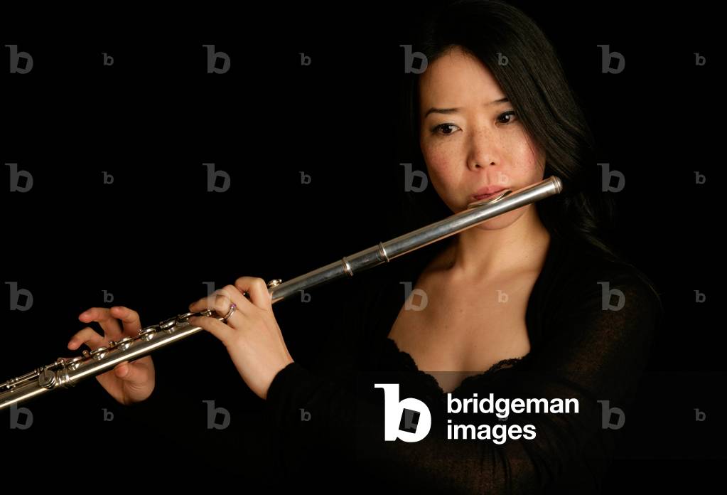 Young woman playing the flute