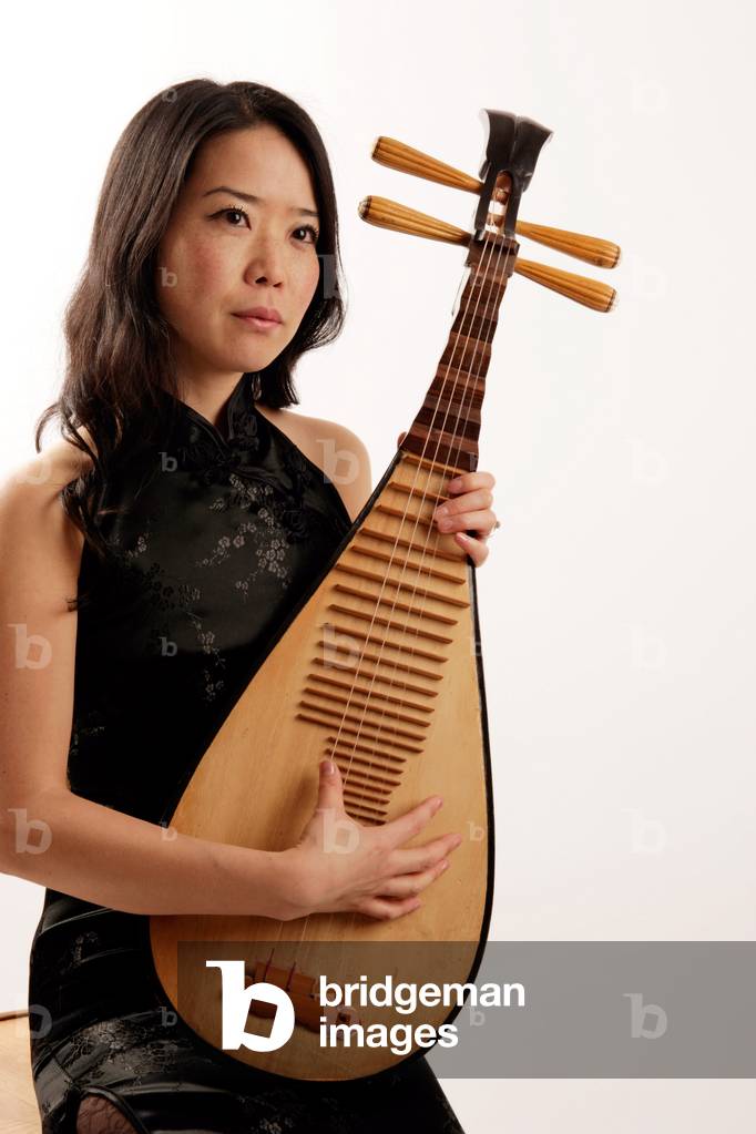 Young Oriental woman playing the Pipa