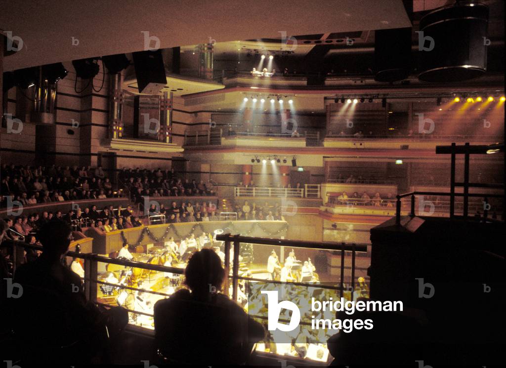 Audience silhouettes watching orchestra