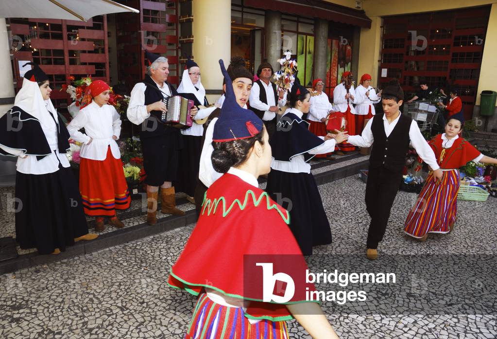Festive folk dancers with folk music group