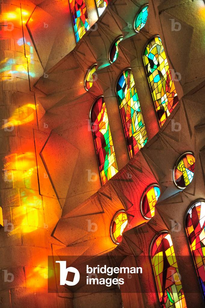 Sagrada Familia. Stained glass windows, with flames effect, in North wall of Barcelona Cathedral of Sagrada Familia