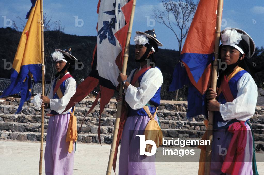 Men in traditional dress holding flags, Suwon Folk Art Village, South Korea
