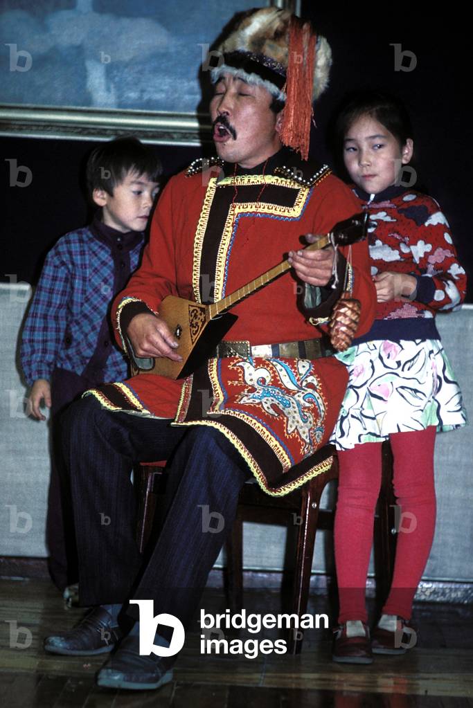 Altai musician singing and playing traditional instrument, Siberia, Russia