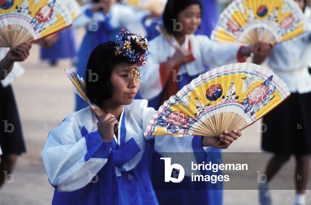 Korean secondary school girls in traditional dress perform fan dance