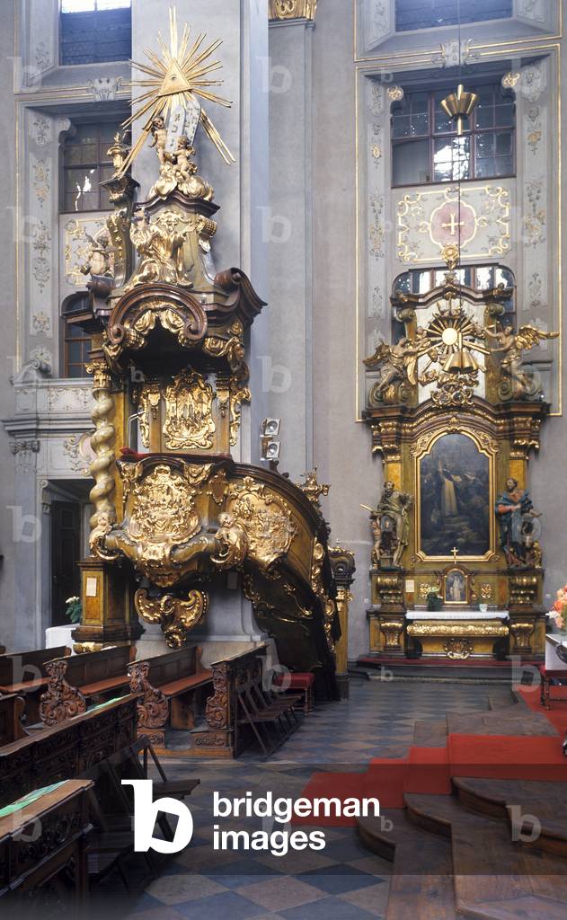 Baroque pulpit and one of the twelve side altars in the Church of St. Giles in Prague, Czech Republic (photo)