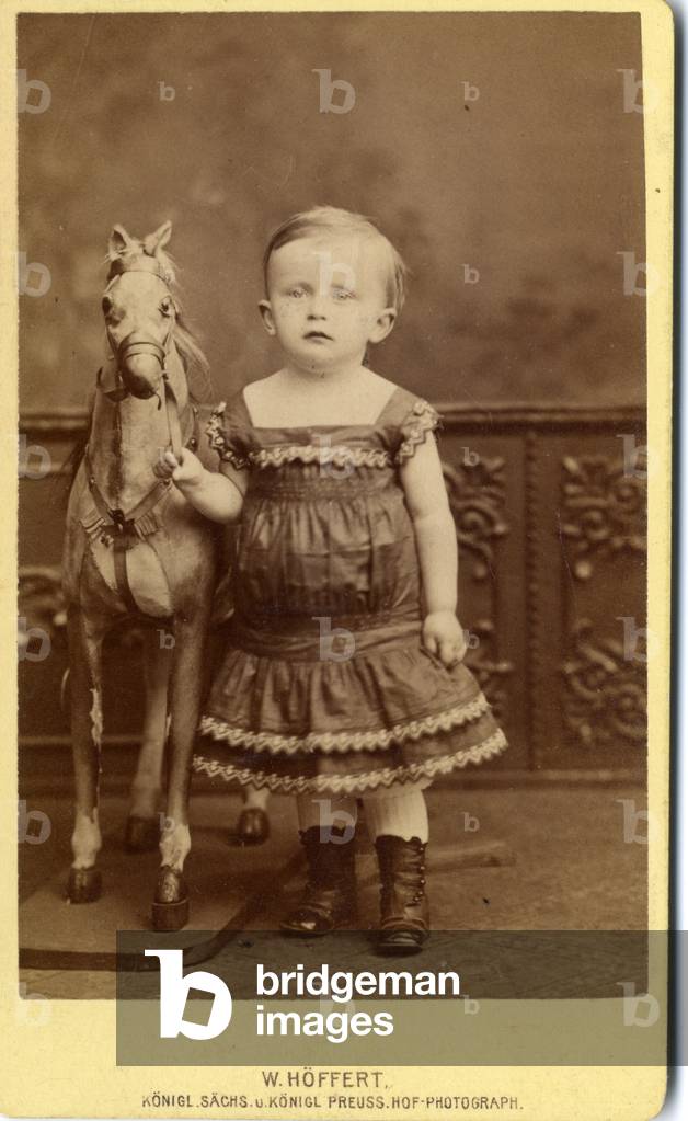 Young girl standing by rocking horse, 1880s (albumen print)