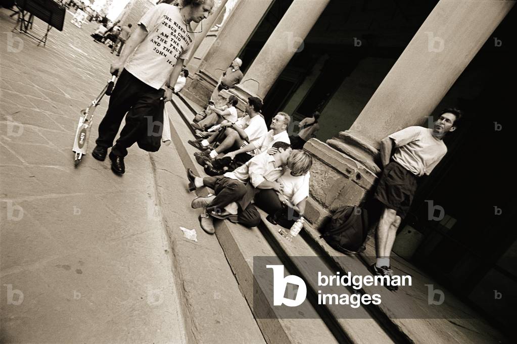Man wearing a 'Jesus' T-shirt staring at lovers, 2004 (photography)