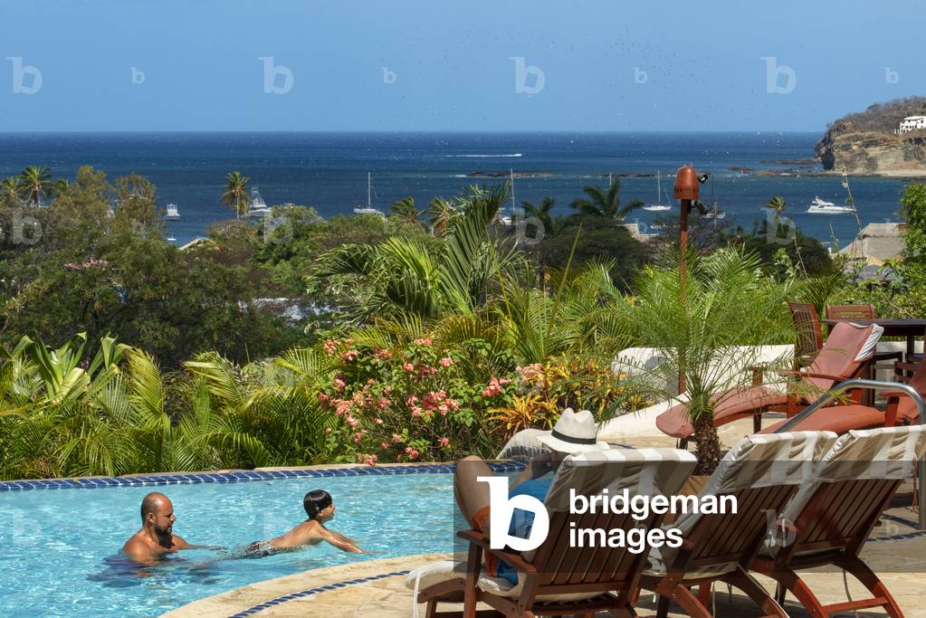Tourists in the swimming pool of Pelican Eyes Resort and Spa in Playa San Juan del Sur beach Nicaragua, Central America, America (photo)